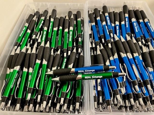 a group of pens in a plastic container