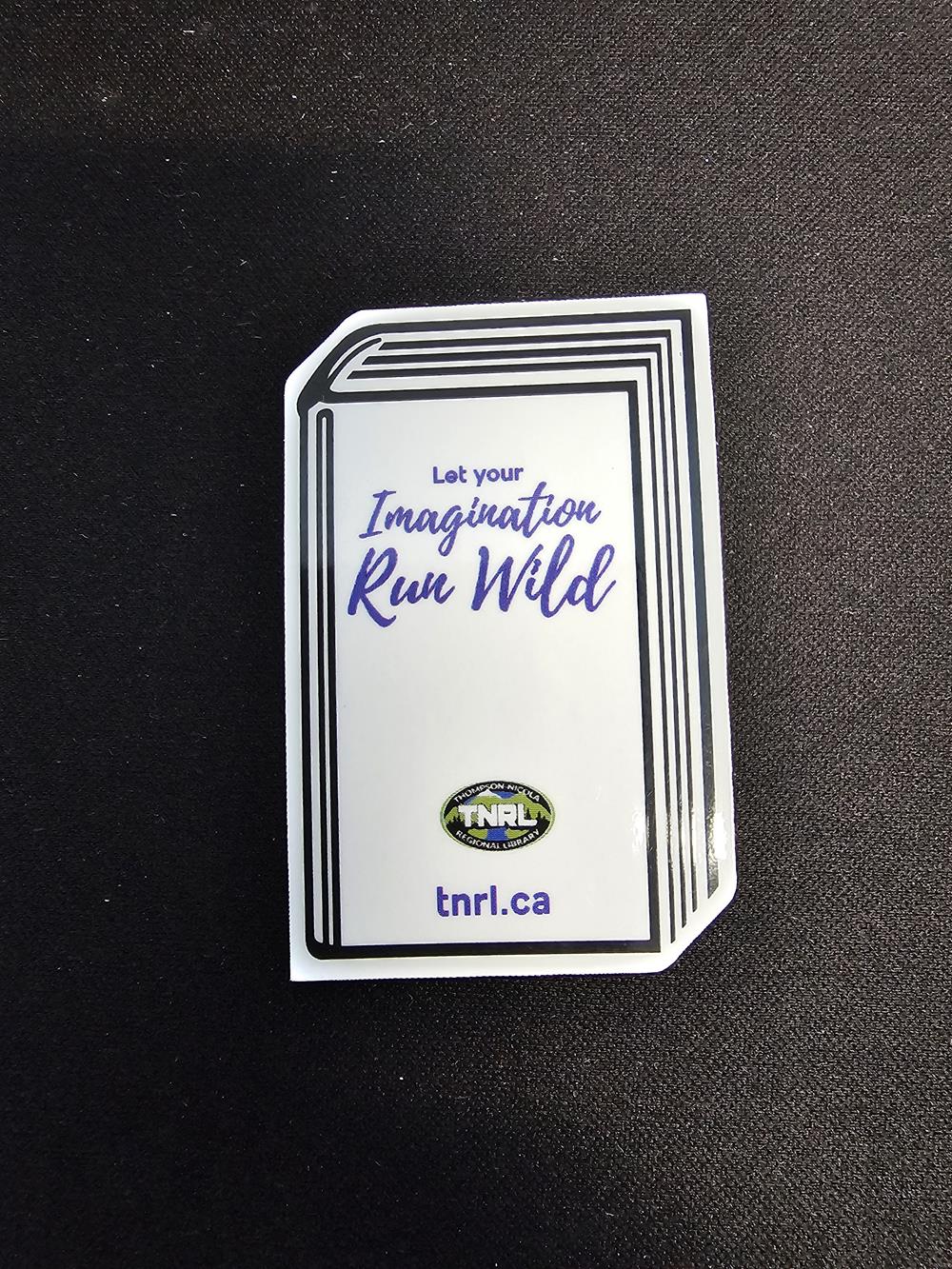 Customer photo from Laura of our Flat Flexible Magnet - Dimensional Rectangle, a white sticker with blue text