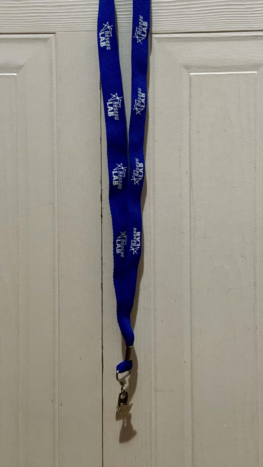 Customer photo from Alex of our Lanyard with Metal Bulldog Clip - 3/4", a blue lanyard with white text on it