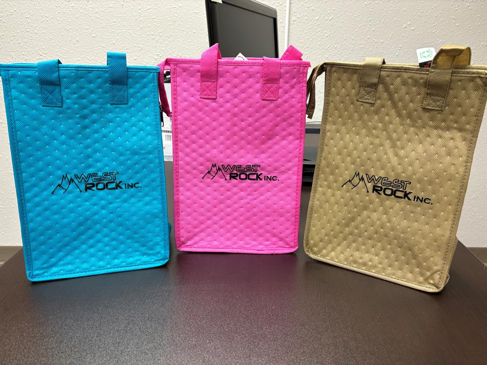 Customer photo from Kathy of our Therm-O Snack Insulated Bag, a group of colorful bags on a table