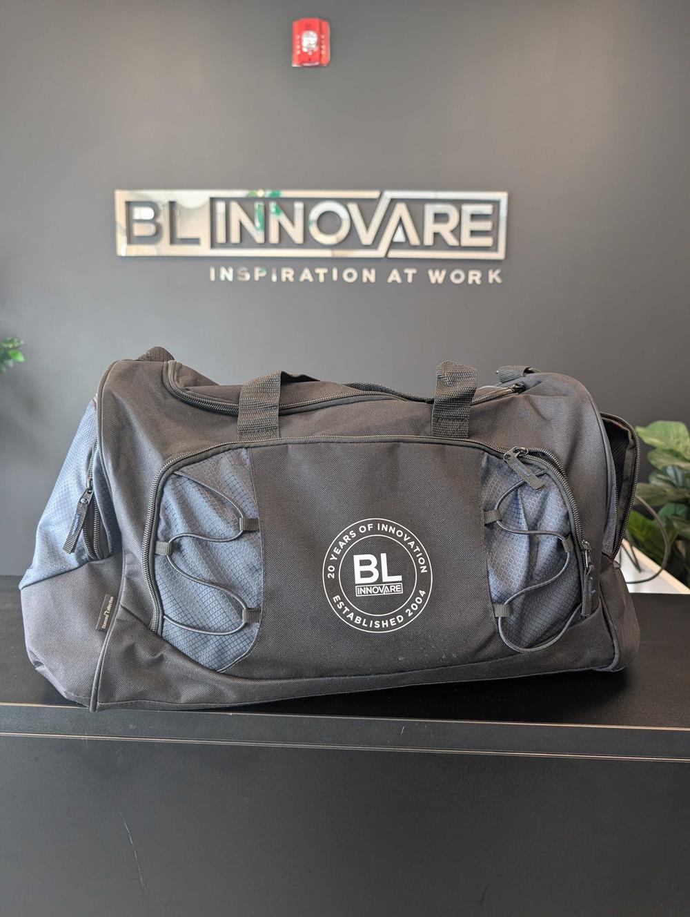 Customer photo from Deonic of our Diamond Rock Duffel, a black duffel bag on a table