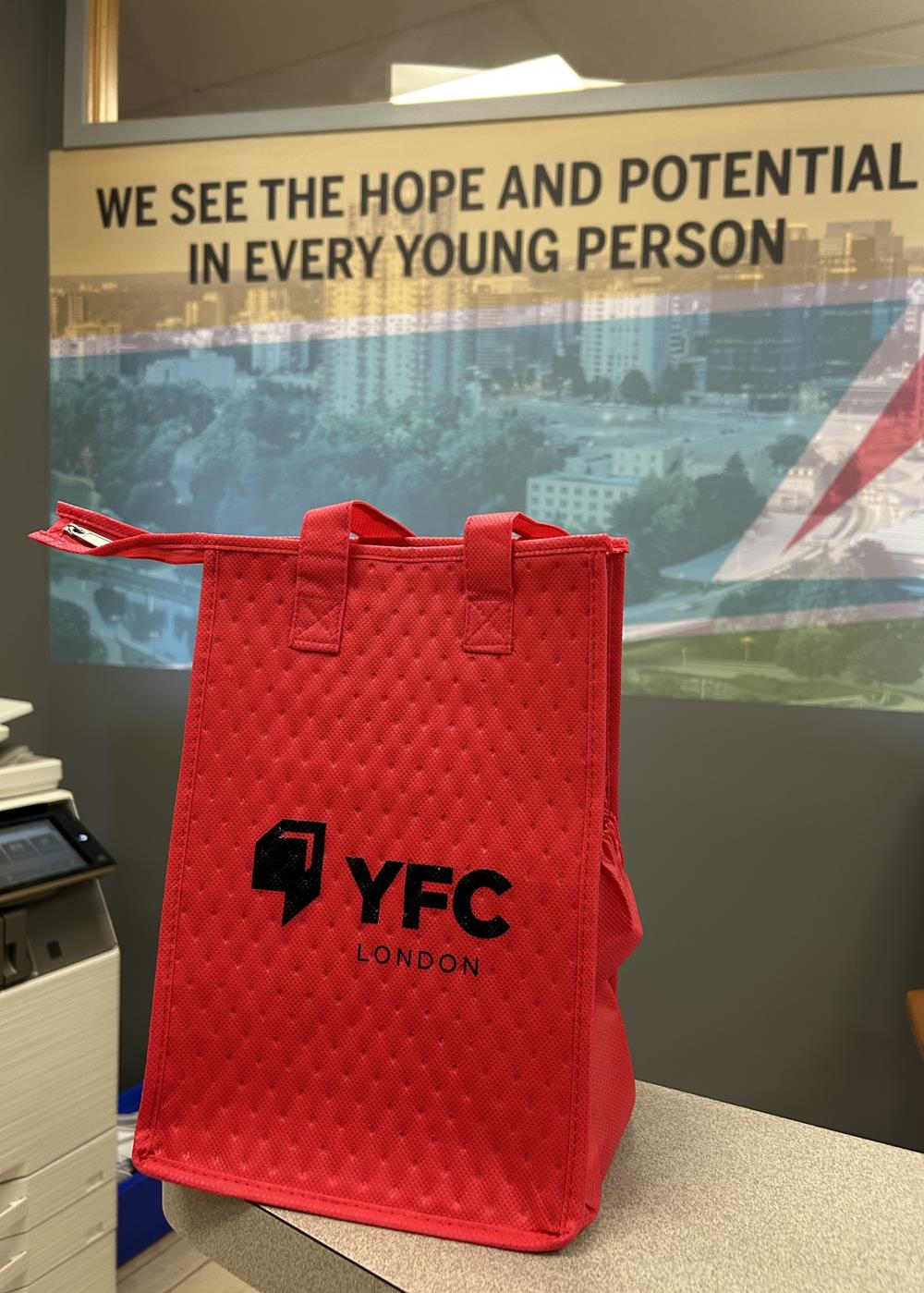 Customer photo from Dan of our Therm-O Snack Insulated Bag, a red bag on a table