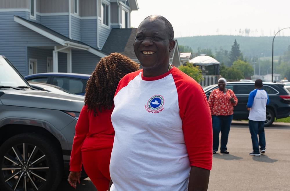 Customer photo from Babatunde of our Gildan Heavy Cotton 3/4 Sleeve Raglan T-Shirt - Screen, a man in a red and white shirt