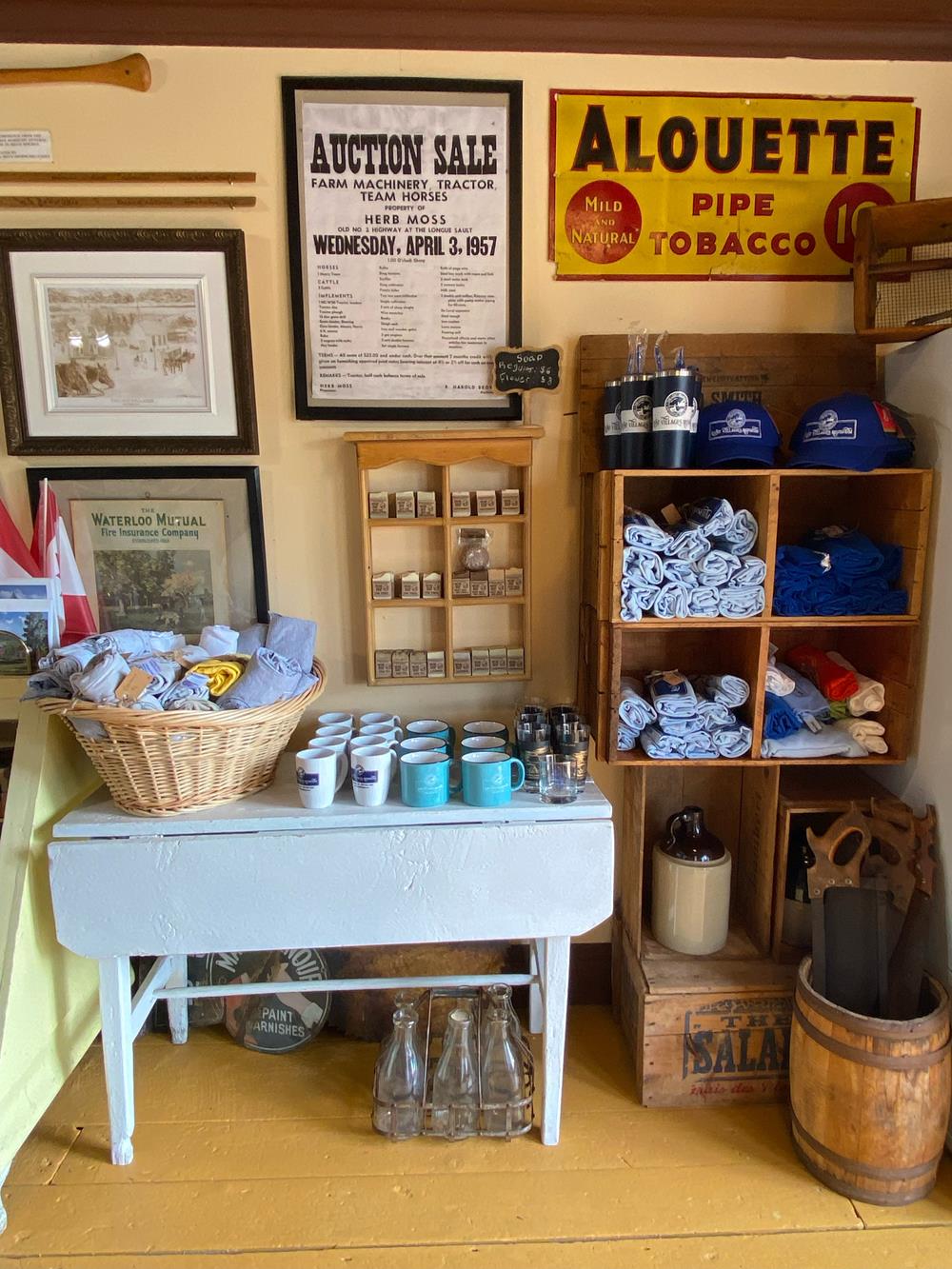 Customer photo from Gloria of our Gildan Ultra Cotton T-Shirt - Men's - Screen - Colours, a room with a table and shelves with towels and a sign