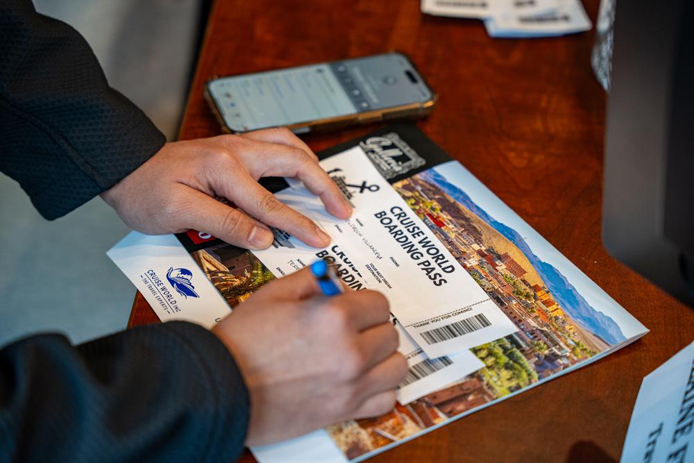 Customer photo from Michaela of our World Travel Appointment Calendar, a person writing on a ticket