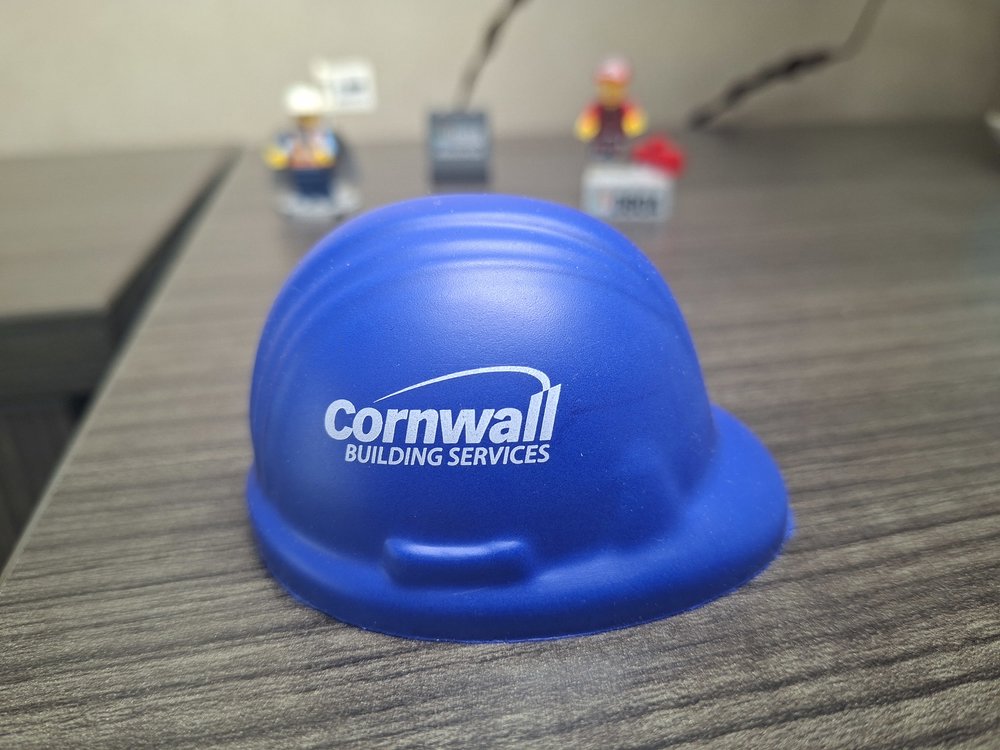 Customer photo from Chris of our Stress Reliever - Hard Hat, a blue hard hat on a table