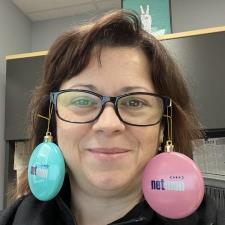 a woman wearing glasses and a pair of earrings