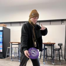 a man holding a purple frisbee