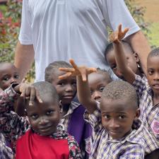 a man standing in front of a group of children