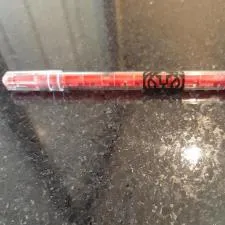 Customer photo from Teresa of our Maze Pen, a red pen on a black surface