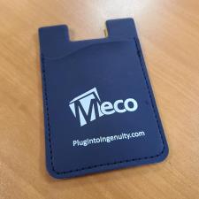 a blue card holder on a wood surface