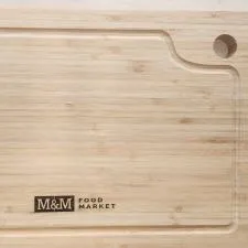 Customer photo from Jason of our Bamboo Cutting Board, a wooden cutting board with a logo on it