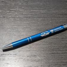 a blue pen on a wood surface