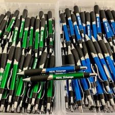 a group of pens in a plastic container