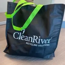 a black bag with a green handle