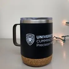 Customer photo from Ali of our Explorer Vacuum Camp Mug with Cork Bottom - 12 oz., a black and gold coffee mug