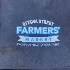 Customer photo from Wendy of our Spree Shopping Tote - 13" x 13", a folded blue cloth with white text