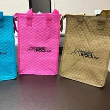 Customer photo from Kathy of our Therm-O Snack Insulated Bag, a group of colorful bags on a table