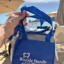 Customer photo from Tara of our Chilton Keychain-Closeout, a hand holding a blue bag