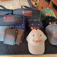 Customer photo from Denise of our Crossland Picnic Blanket - Screen, a group of hats and notebooks on a table