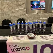 Customer photo from Malik of our Individual Chocolate Squares, a table with water bottles and pens