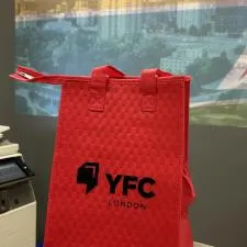 Customer photo from Dan of our Therm-O Snack Insulated Bag, a red bag on a table