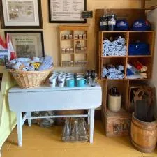 Customer photo from Gloria of our Gildan Ultra Cotton T-Shirt - Ladies' - Screen - Colours, a room with a table and shelves with towels and a sign