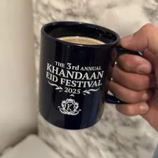 Customer photo from HASAN of our Value Coffee Mug - 11 oz. - Colours, a hand holding a coffee mug