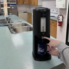 Customer photo from Lilian of our Value Coffee Mug - 11 oz. - Colours, a person holding a coffee cup