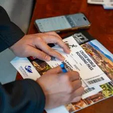 Customer photo from Michaela of our World Travel Appointment Calendar, a person writing on a ticket