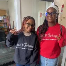 Customer photo from Babatunde of our Gildan 50/50 Heavy Blend Crew Sweatshirt - Screen, two women standing in a room
