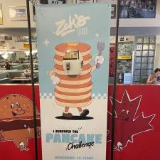 Customer photo from James of our FrameWorx Banner Stand - Single Face Cut Out, a sign with a cartoon character on it